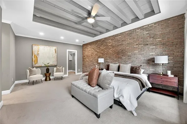 a bedroom with furniture and a large window