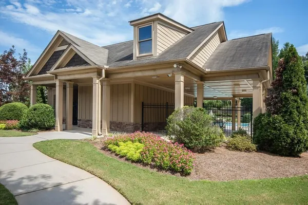 a front view of a house with a yard and potted plants