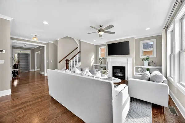 a living room with furniture a fireplace and a flat screen tv