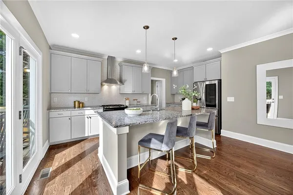 a kitchen with white cabinets and counter space