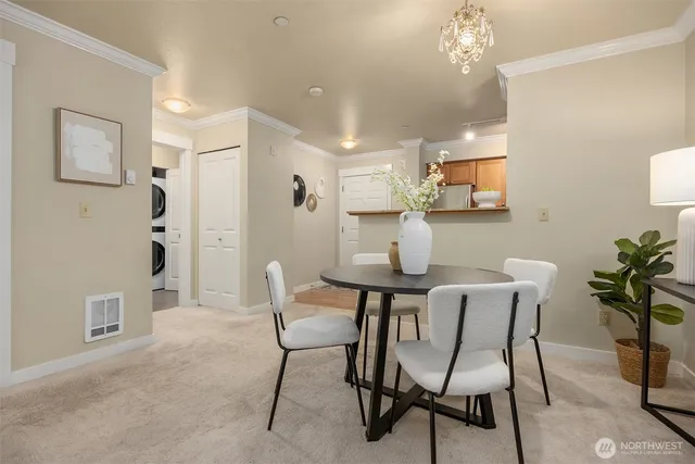 a view of a dining room with furniture and chandelier