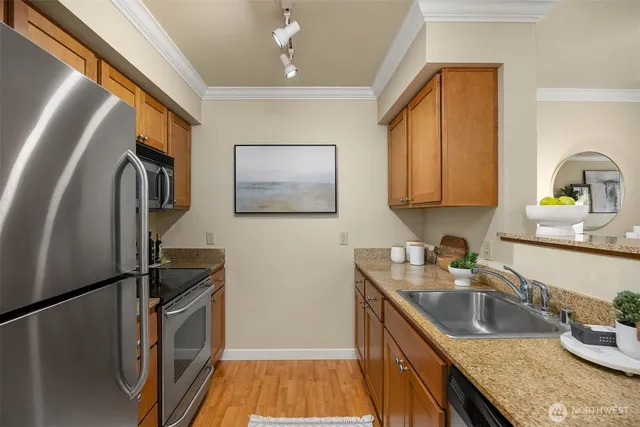 a kitchen with stainless steel appliances granite countertop a sink stove and refrigerator