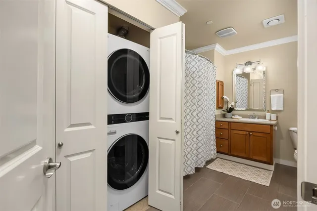 a bathroom with a sink a washer and dryer