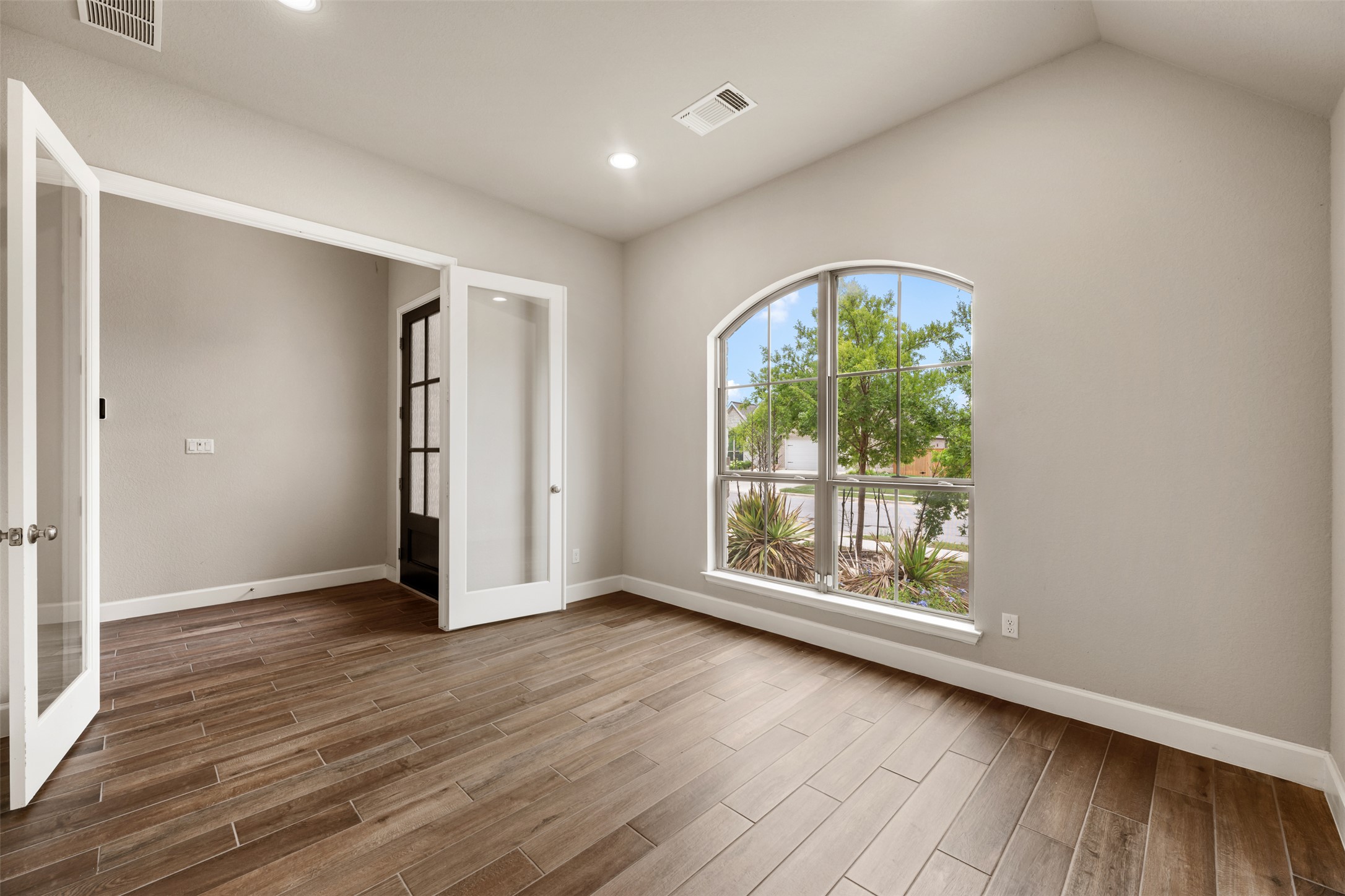 104 Anejo Bluff Georgetown, TX 78628 - Photo 5 of 40 an empty room with wooden floor and windows