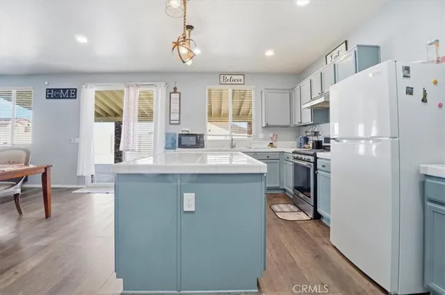 a kitchen with refrigerator cabinets and large window