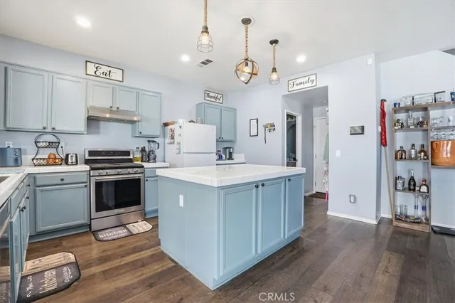 a kitchen with a sink stove and cabinets