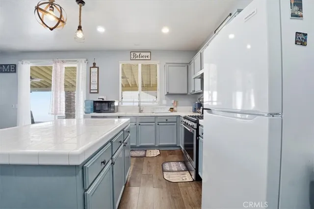 a kitchen with a refrigerator and a sink