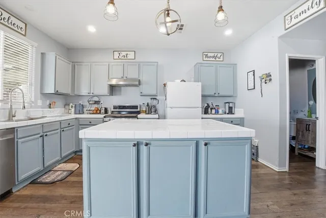 a kitchen with a sink a stove and cabinets