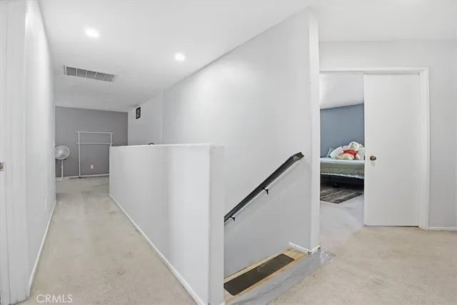 a hallway with a white cabinets
