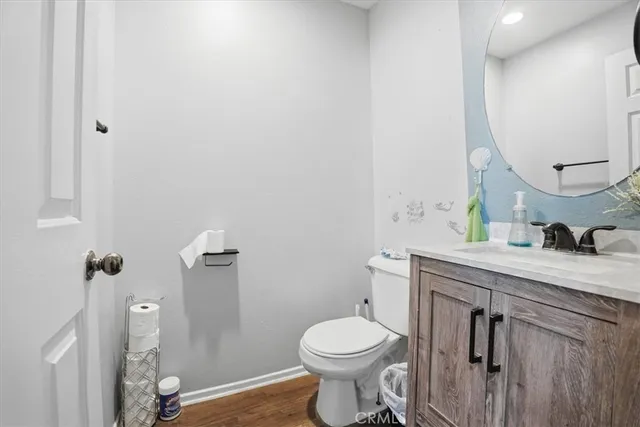 a bathroom with a granite countertop toilet sink and mirror