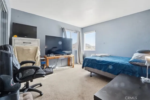 a bedroom with furniture and a flat screen tv