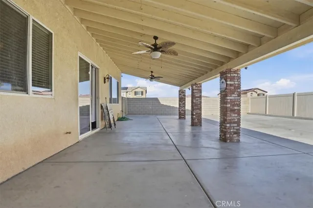 a view of a livingroom with wooden floor and a ceiling fan