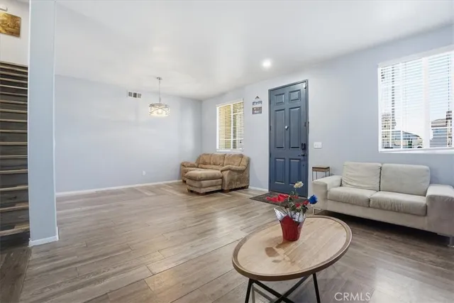 a living room with furniture and a mirror