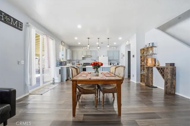 a dining room with furniture and wooden floor