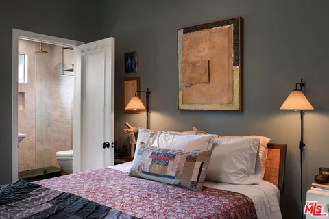 a bedroom with a bed and a lamp