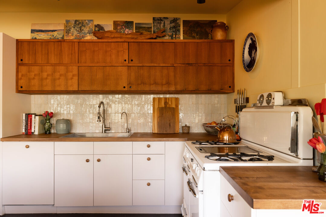 1452 Westerly Terrace Los Angeles, CA 90026 - Photo 22 of 39 a kitchen with granite countertop a stove and cabinets
