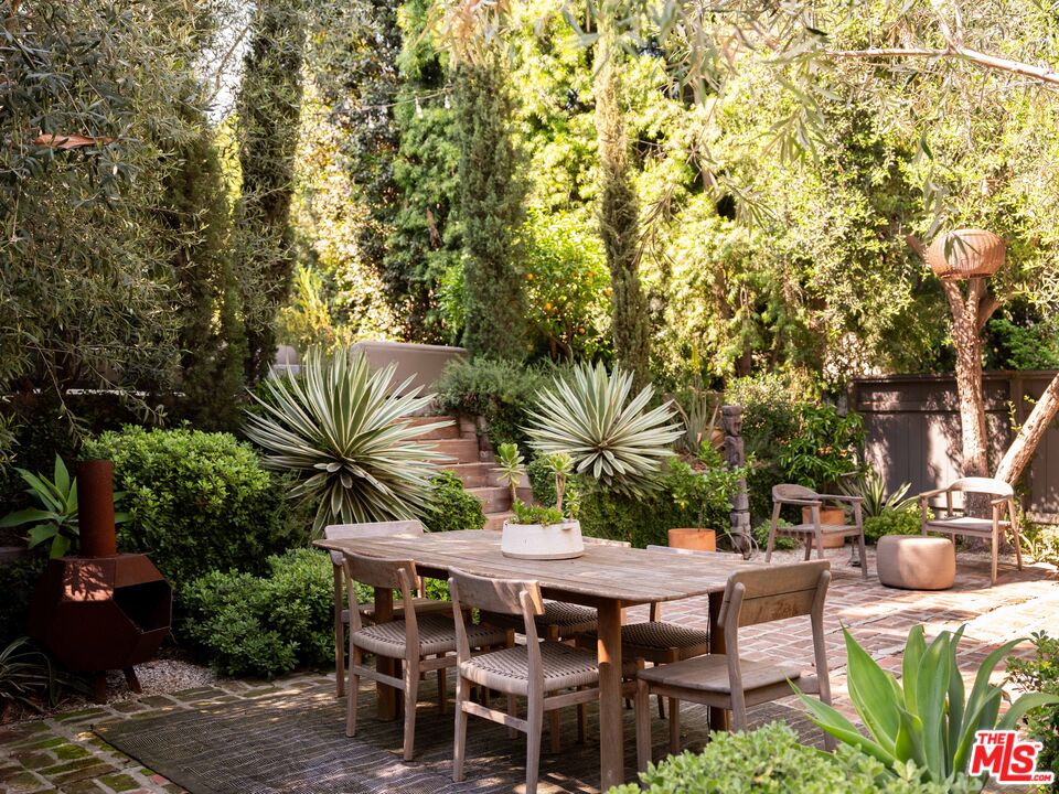 1452 Westerly Terrace Los Angeles, CA 90026 - Photo 29 of 39 a backyard of a house with table and chairs