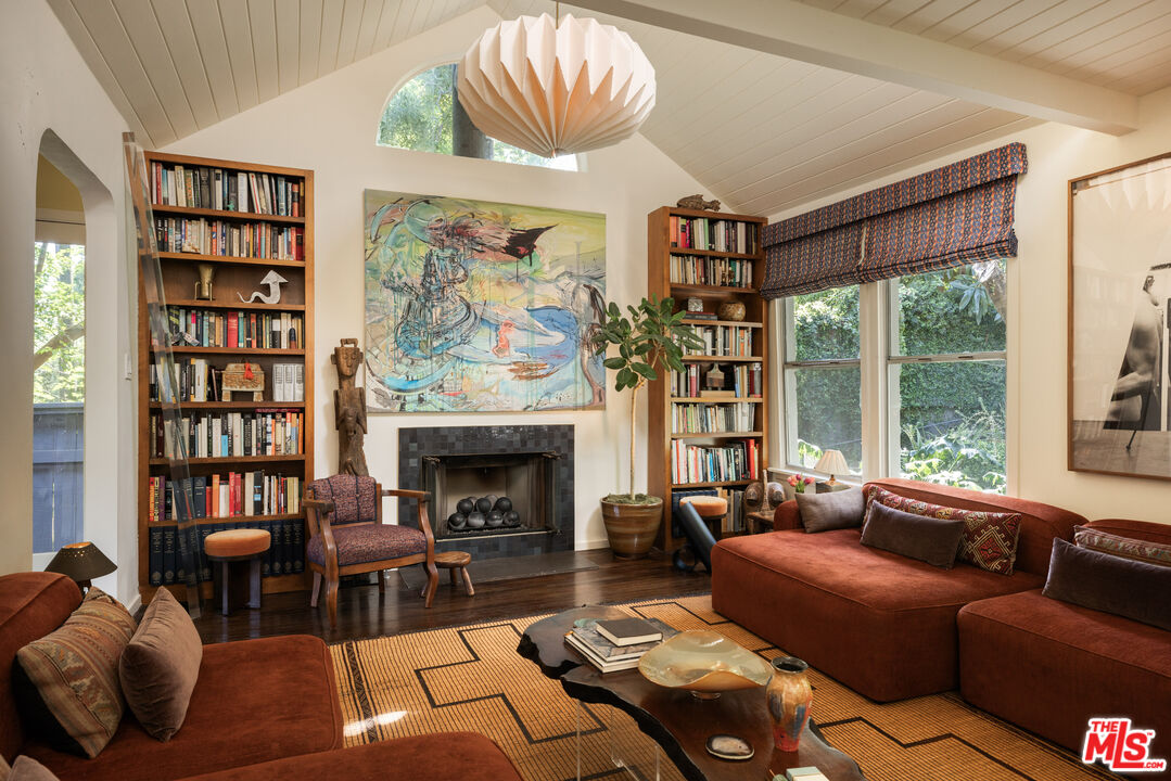 1452 Westerly Terrace Los Angeles, CA 90026 - Photo 4 of 39 a living room with furniture a bookshelf and a fireplace