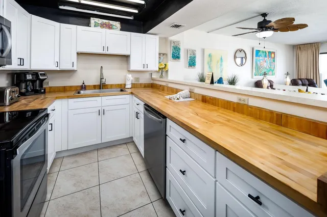 a kitchen with a sink window and cabinets