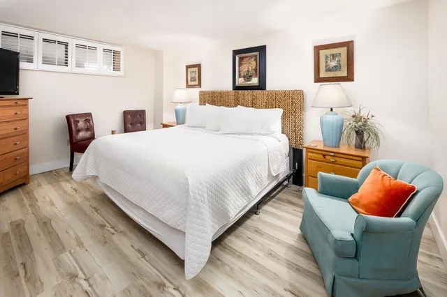 a bedroom with bed and a couch