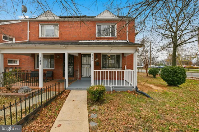 a view of a house with a porch and furniture