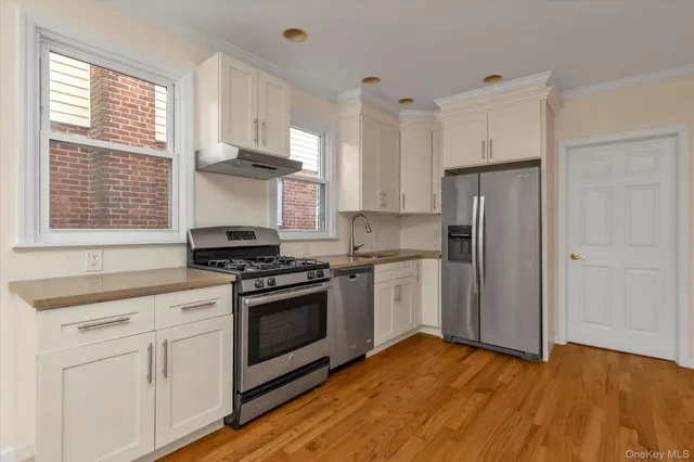 a kitchen with a stove a refrigerator and a sink