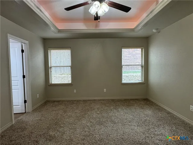a view of room with window and ceiling fan