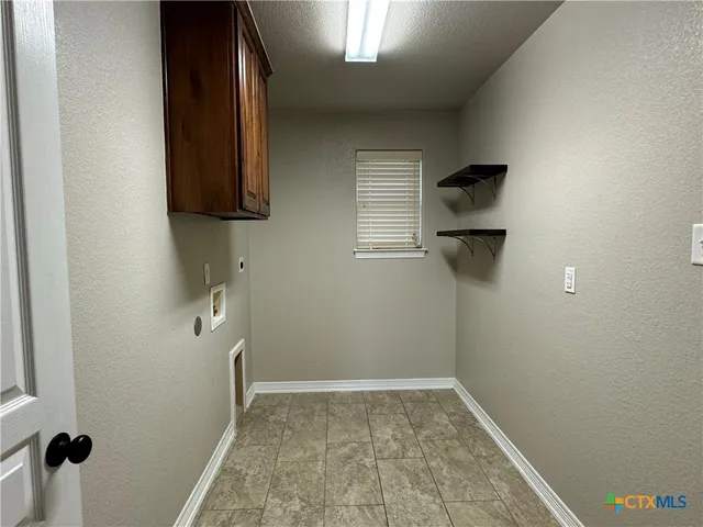 a view of a room with wooden floor and iron fence