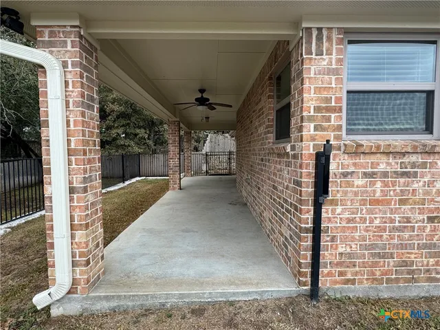 a view of a patio with a table and chairs