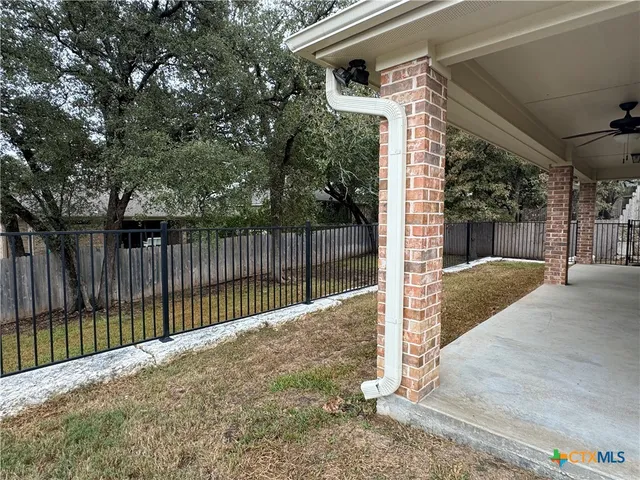 a view of a house with a door and wooden fence