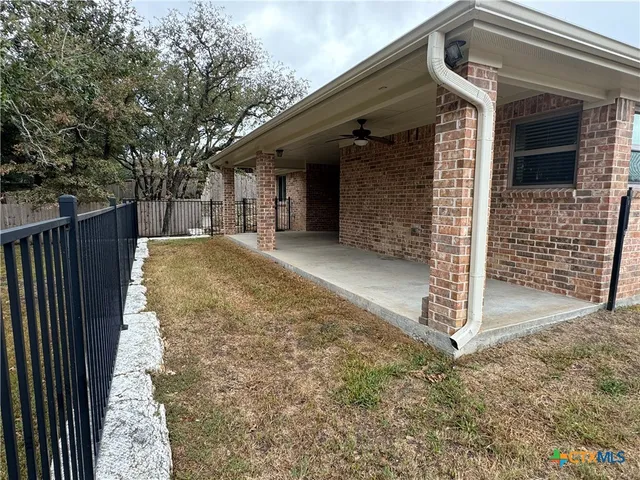 a front view of house with yard and trees in the background