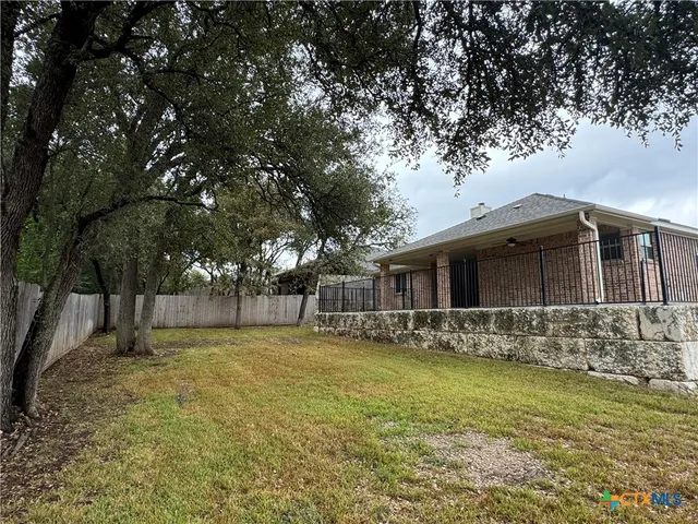 a front view of house with yard and trees