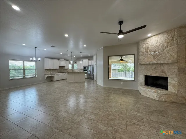 a view of kitchen with kitchen island wooden floor and living room
