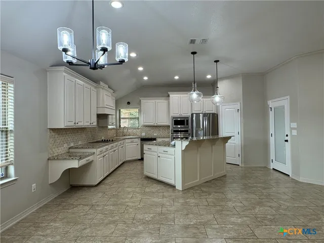 a kitchen with counter top space cabinets and stainless steel appliances