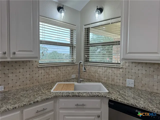 a kitchen with sink and window