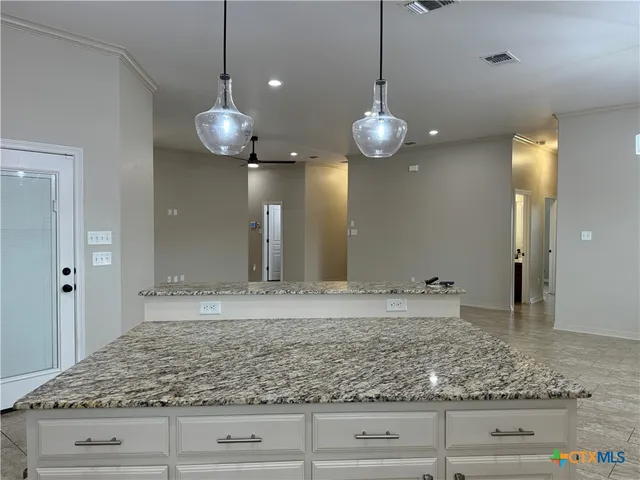 a view of a kitchen and kitchen island