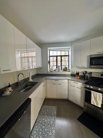 a kitchen with a sink stove and cabinets