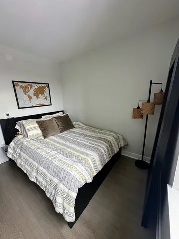 a bedroom with bed and cupboard