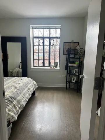 a bed sitting in a bedroom next to a window