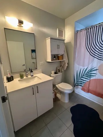 a bathroom with a sink a toilet and mirror