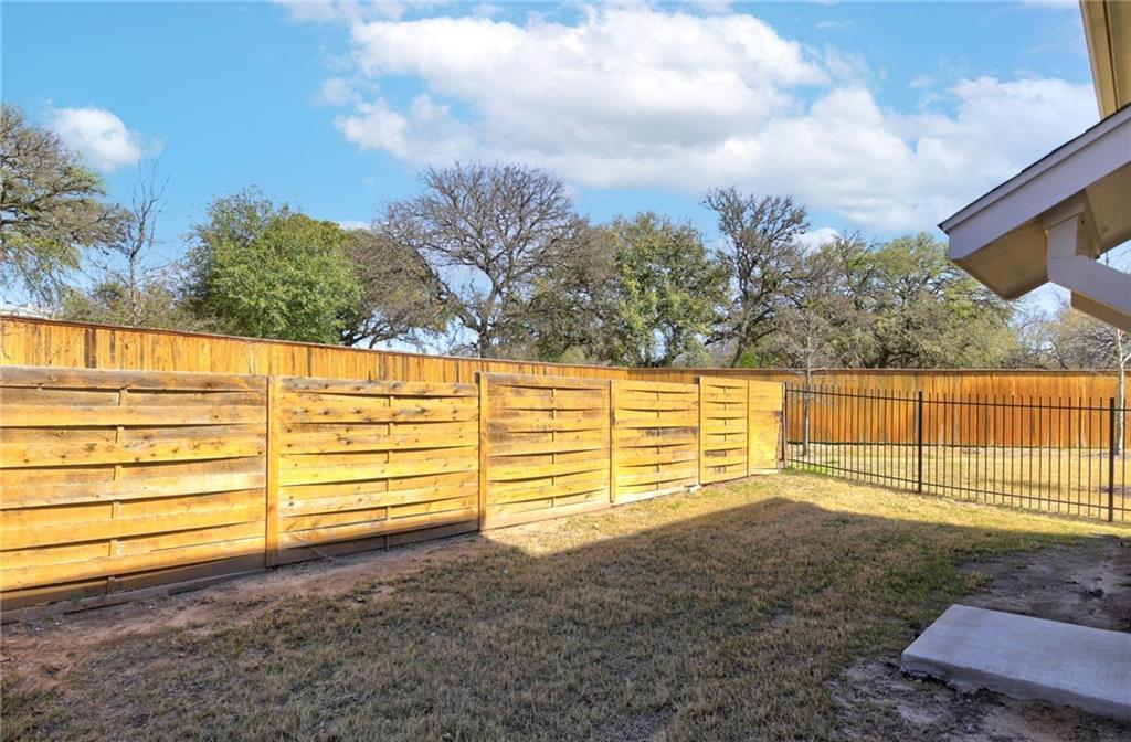 5809 Swayden Lane Austin, TX 78745 - Photo 11 of 13 Secure backyard with sturdy wood fencing and a separate wrought iron section.