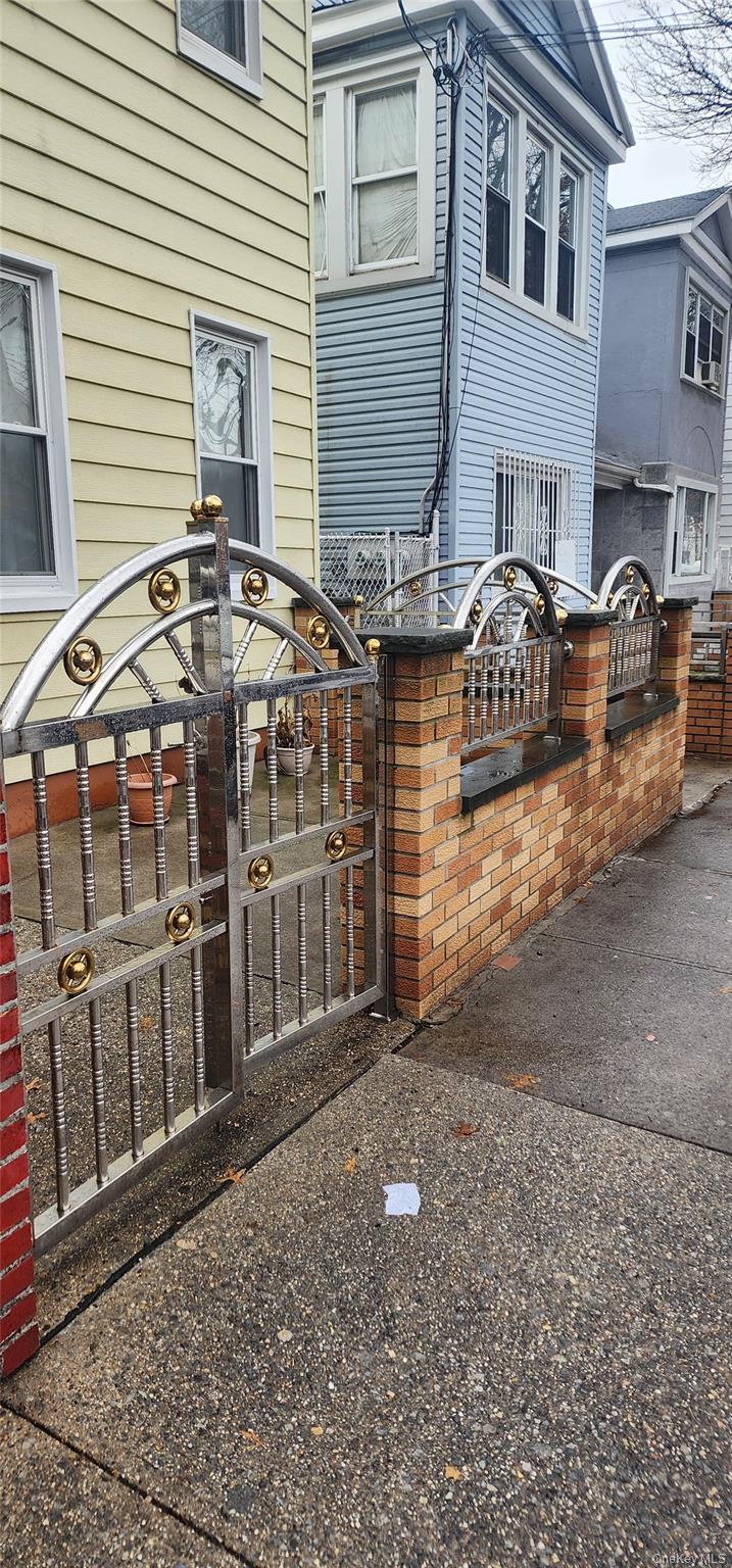 98-44 Corona Avenue Queens, NY 11368 - Photo 2 of 5 a front view of a house with parking space