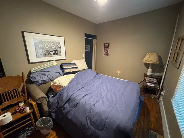 a bedroom with a bed and a dresser