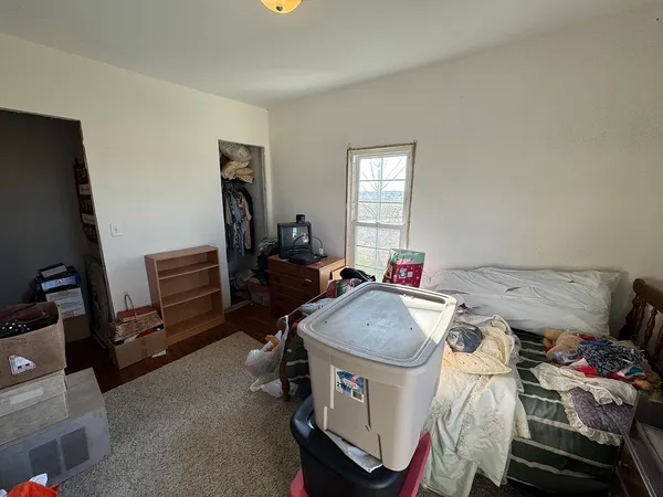 a living room with furniture a window and gym equipment