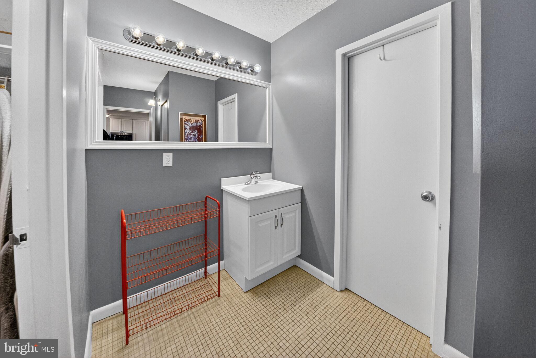 4242 East-West Highway, Unit 714 Chevy Chase, MD 20815 - Photo 13 of 29 Vanity with sink outside of full bathroom