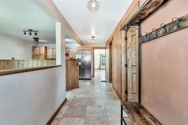 a view of a hallway with wooden shelves