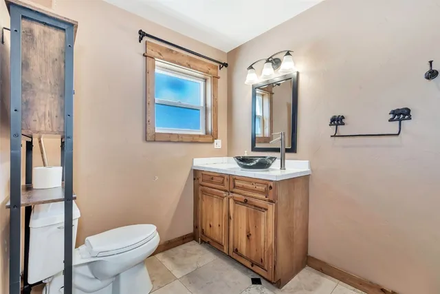 a bathroom with a toilet sink and mirror