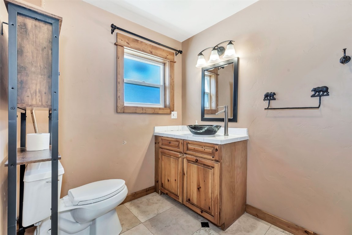 21505 4th Avenue Phippsburg, CO 80469 - Photo 25 of 44 a bathroom with a toilet sink and mirror