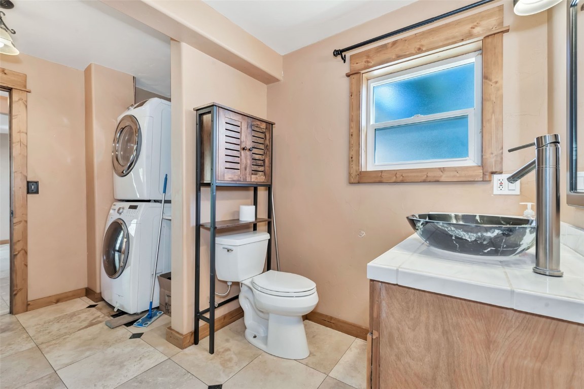 21505 4th Avenue Phippsburg, CO 80469 - Photo 26 of 44 a bathroom with a toilet a sink and a mirror