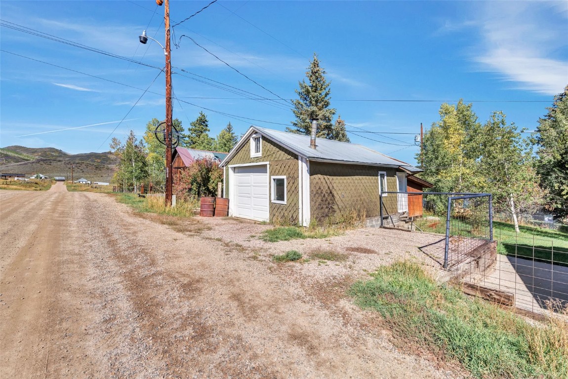 21505 4th Avenue Phippsburg, CO 80469 - Photo 35 of 44 a front view of a house with a yard and mountain view